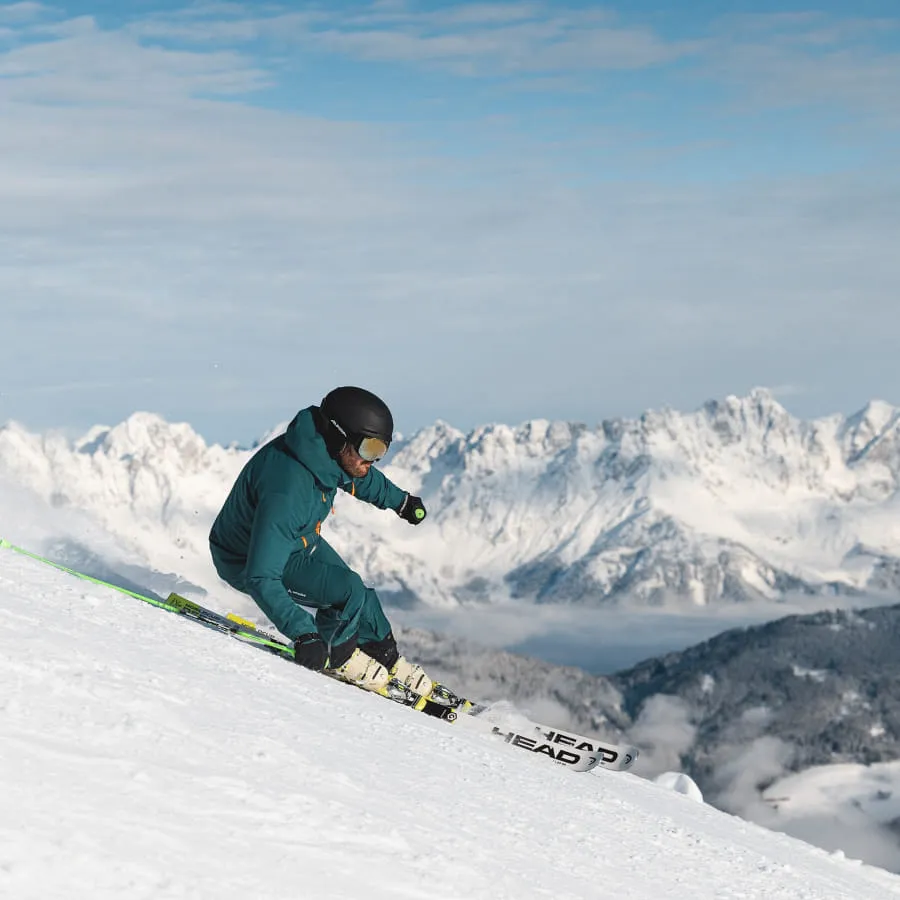 Skifahrer im Schnee mit Bergen im Hintergrund